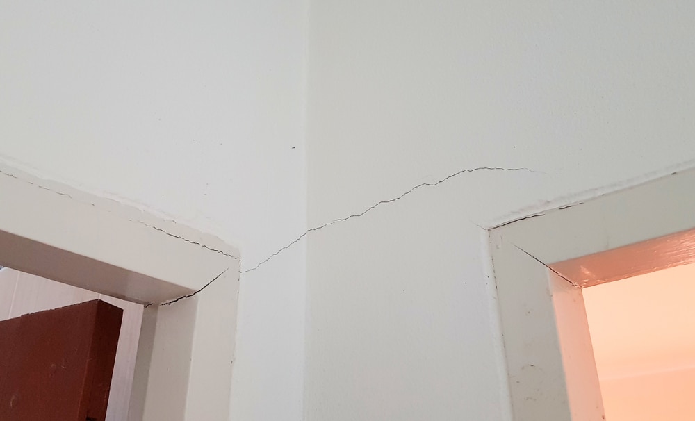 Cracked drywall by door frame due to foundation issues