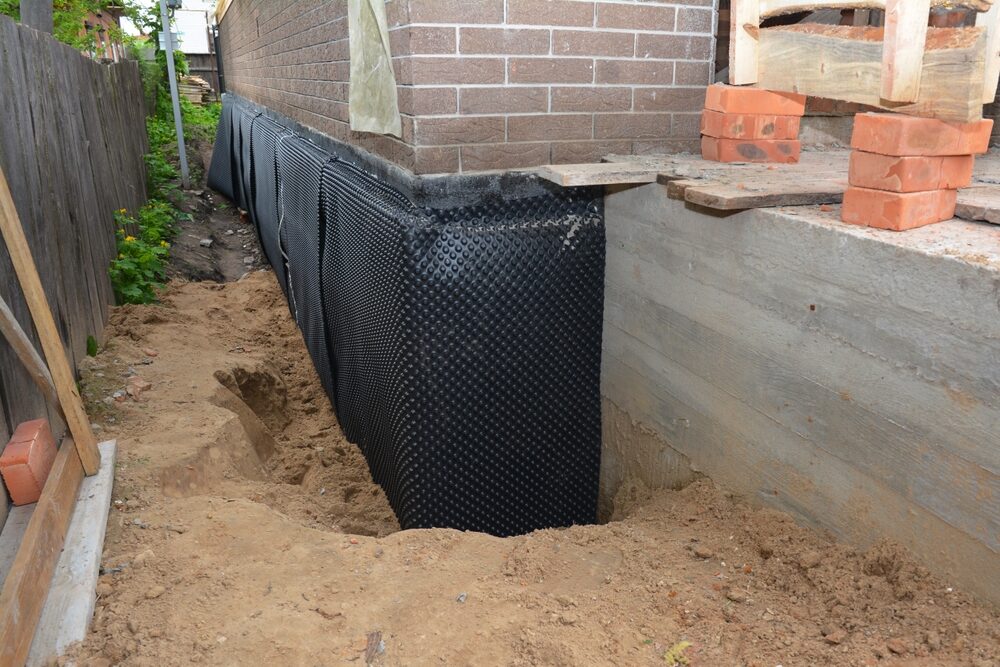 Basement waterproofing exterior in progress